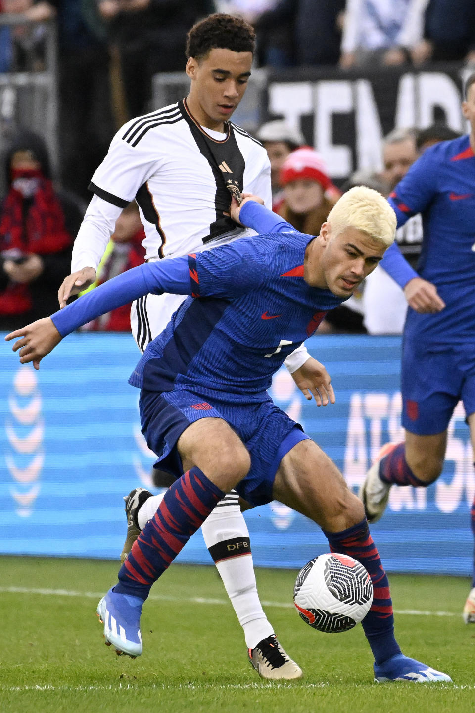 United States' Gio Reyna, front, shields the ball from from Germany's Jamal Musiala during an international friendly soccer match at Pratt & Whitney Stadium at Rentschler Field, Saturday, Oct. 14, 2023, in East Hartford, Conn. (AP Photo/Jessica Hill)