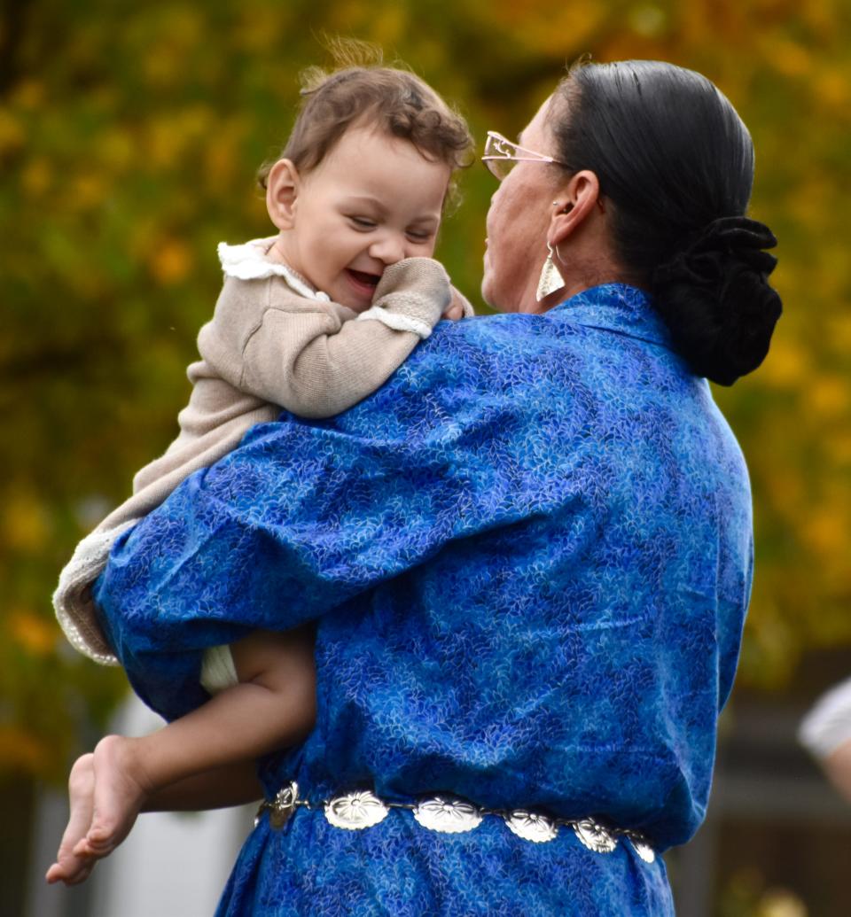 One-year-old Emmie Ferguson squeals with delight as she dances in the arms of her grandmother, Onondaga Seed Keeper Angela Ferguson, on Saturday at Binghamton University for the seventh annual Haudenosaunee Festival