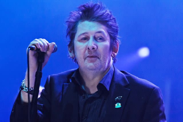 <p>Joseph Okpako/Redferns via Getty </p> Shane MacGowan of The Pogues performs on stage at Brixton Academy in December 2013 in London