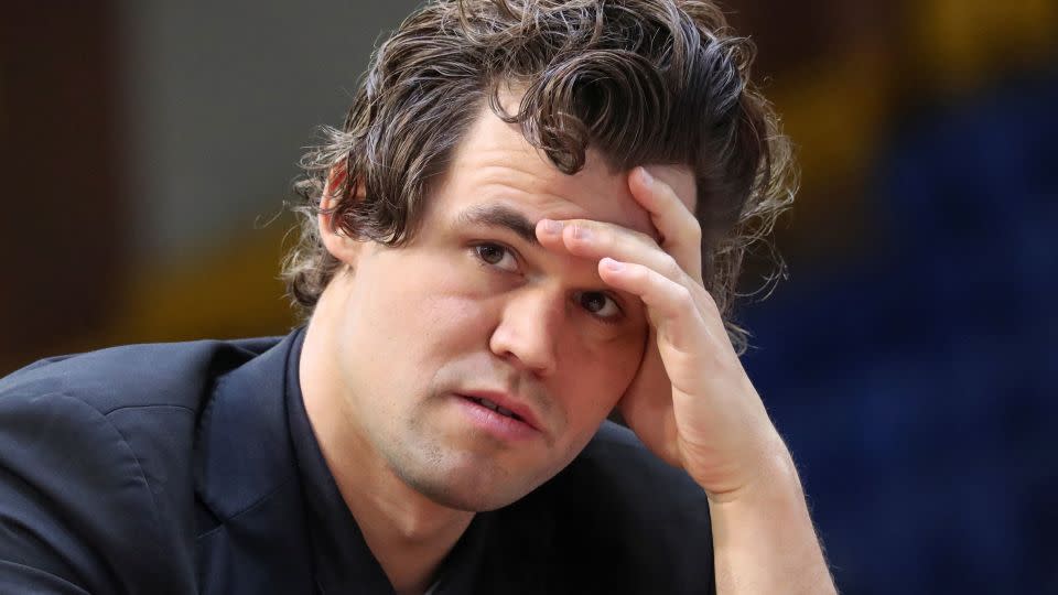 Carlsen sits in front of the chess board during a game at the 2022 World Rapid and Blitz Championships. - Pavel Mikheyev/Reuters