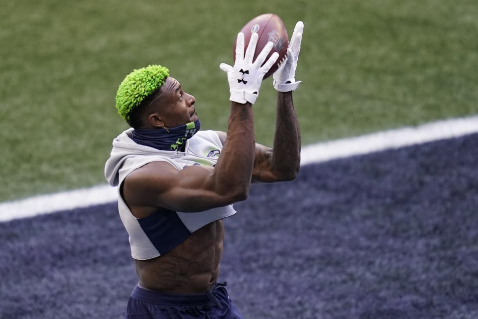 Seattle Seahawks wide receiver DK Metcalf catches a pass as he warms up before an NFL football game against the Los Angeles Rams, Sunday, Dec. 27, 2020, in Seattle. (AP Photo/Elaine Thompson)