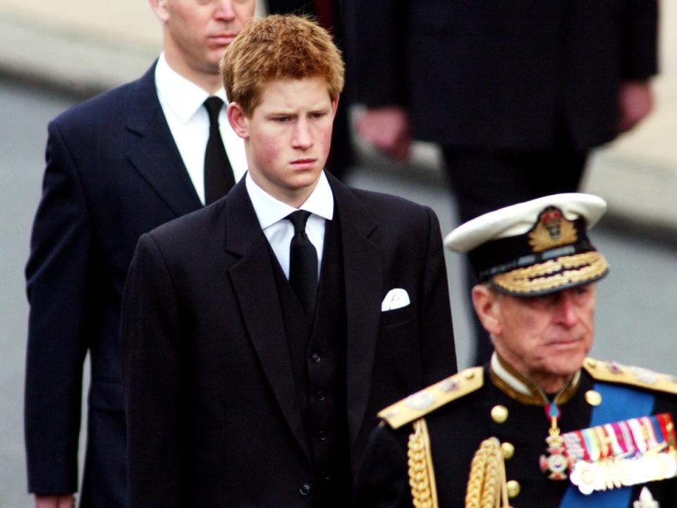 The prince during a funeral procession for the late Queen Mother in 2002 (Getty)