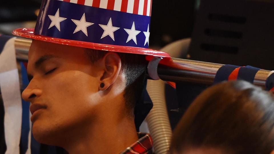 A student sleeps at the University of Sydney as he joins a large crowd watching the US Election at The United States Studies Centre election party. Photo: AAP