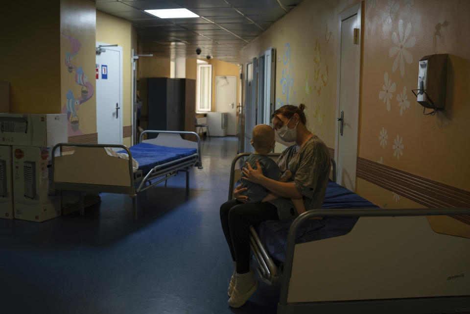 Oksana Halak hugs her son Dmytro, 2, at the National Cancer Institute, in Kyiv, Ukraine, Wednesday, July 10, 2024. (AP Photo/Alex Babenko)