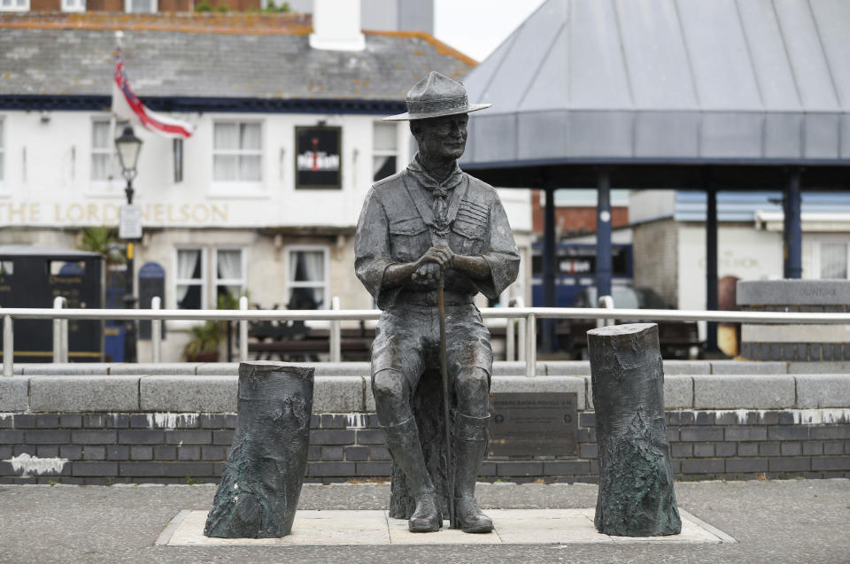 A statue of the founder of the Scout movement Robert Baden-Powell on Poole Quay in Dorset, England ahead of its expected removal to "safe storage" following pressure to remove it over concerns about his alleged actions while in the military and "Nazi sympathies" Thursday June 11, 2020. (Andrew Matthews/PA via AP)