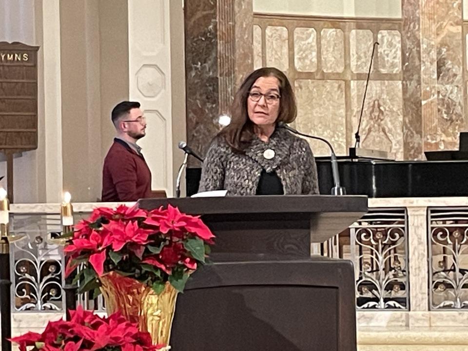 Stephanie Kasprzak is shown at Monday's prayer service. In the background is Richard (Ricky) Cicco of Toledo, the IHM's new director of music and liturgy. He began his new job on Monday.