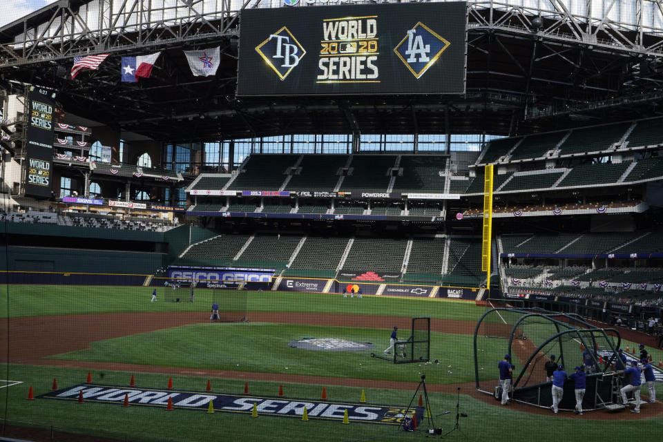 Members on the Los Angeles Dodgers take warms up during batting practice before Game 1 of the baseball World Series Series against the Tampa Bay Rays Tuesday, Oct. 20, 2020, in Arlington, Texas. (AP Photo/Sue Ogrocki)