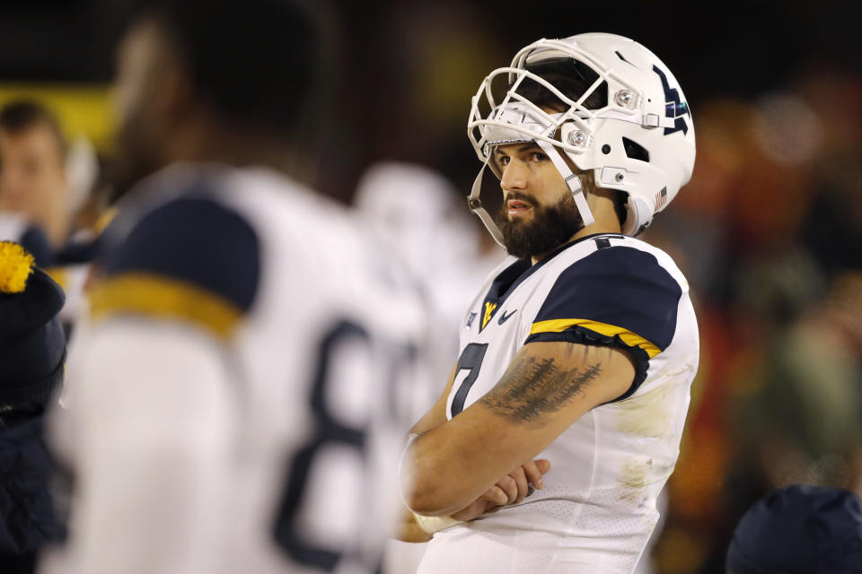 West Virginia quarterback Will Grier watches from the bench during the second half of an NCAA college football game against Iowa State, Saturday, Oct. 13, 2018, in Ames, Iowa. (AP Photo/Charlie Neibergall)