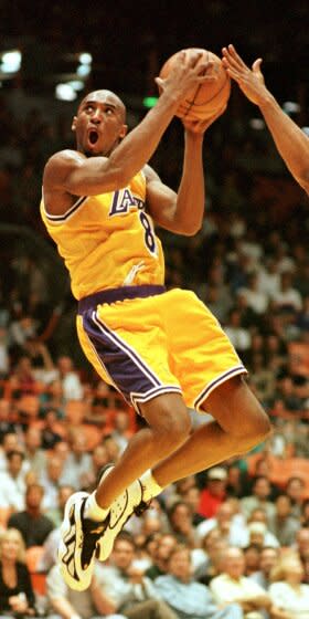 FILE - Los Angeles Lakers' Kobe Bryant (8) of the goes in shot against the Utah Jazz.