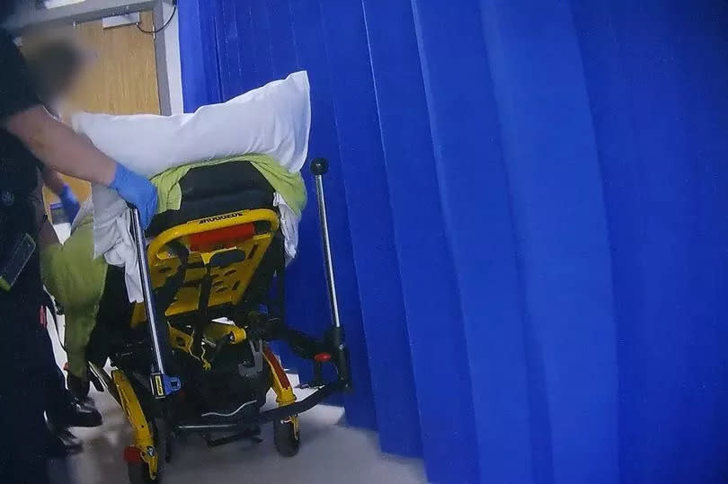 An ambulance crew leaving a patient in the ambulance reception area