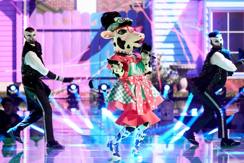 A costumed performer dressed as a cow wearing a dress is seen on the season 10 premiere of "The Masked Singer."