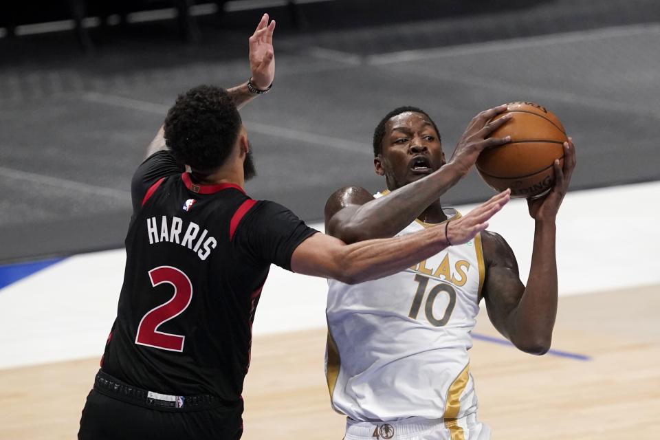 Toronto Raptors' Jalen Harris (2) defends as Dallas Mavericks forward Dorian Finney-Smith (10) works to the basket in the first half of an NBA basketball game in Dallas, Friday, May 14, 2021. (AP Photo/Tony Gutierrez)