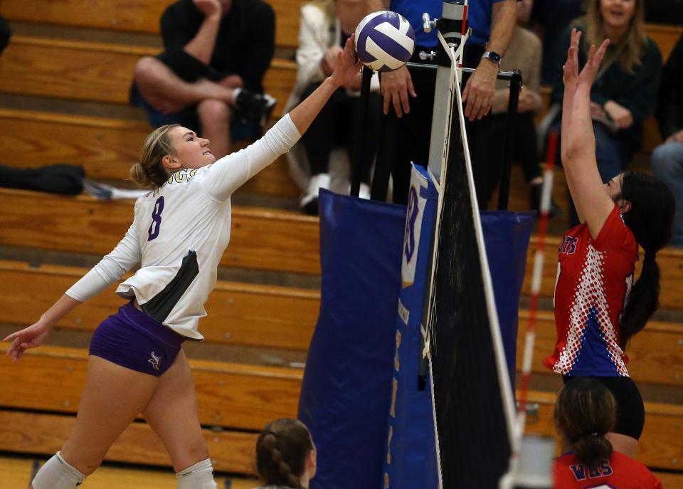 North Kitsap’s Iliana Brockett (8) hits the ball over the net as Washington’s Louden Leia goes up for a block during the WCD/SW Bi-District 2A tournament at Bremerton High School on Saturday, Nov. 4, 2023.