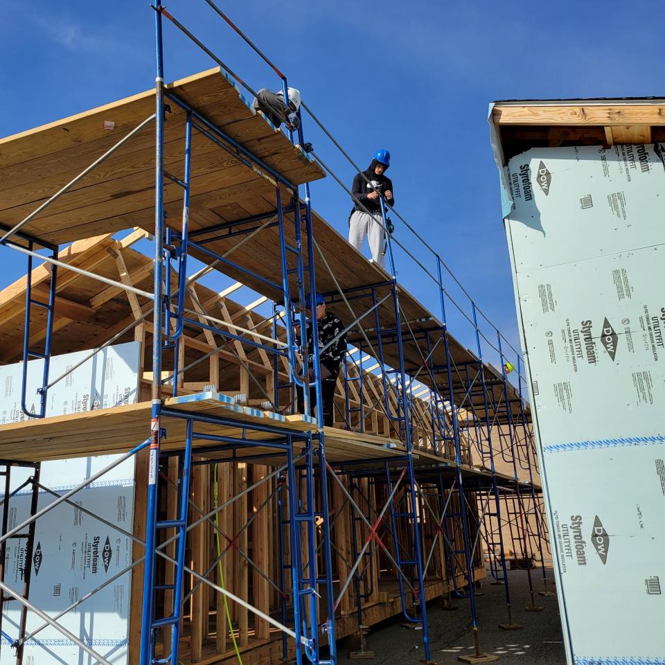 Students construct a Morris Habitat for Humanity three-bedroom home on the campus of Roxbury High School. When complete, two sections of construction will be moved to a permanent location in town.