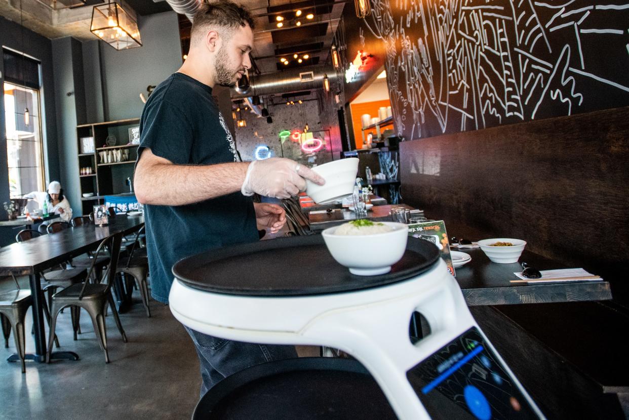 Ani Ramen in Cranford, NJ uses a robot server called Rosey to assist the servers deliver and clear the tables. Estevan Luciano unloads food from Rosey on Thursday June 9, 2022. 