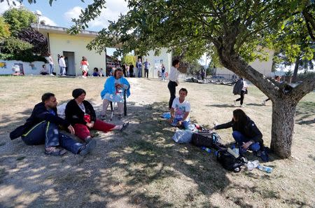 People rest in a garden following an earthquake in Amatrice, central Italy, August 24, 2016. REUTERS/Ciro De Luca