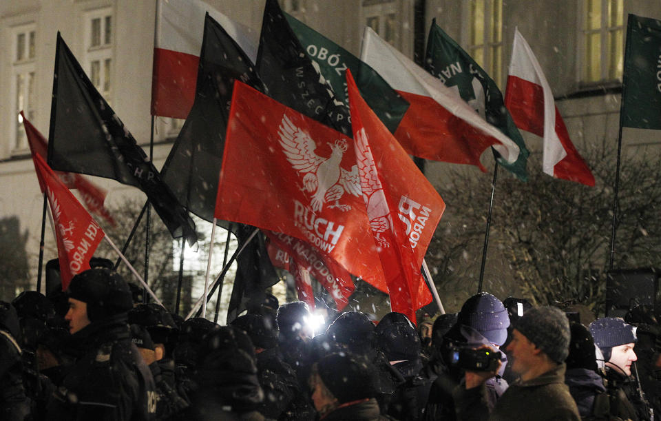 FILE - In this Monday, Feb. 5, 2018 file photo, far-right groups hold a demonstration in front of the presidential palace to call on President Andrzej Duda to sign a bill that would limit some forms of Holocaust speech in Warsaw, Poland. Two Polish historians are facing a libel trial for a scholarly examination of Polish behavior during World War II, a case whose outcome is expected to determine the fate of independent Holocaust research under Poland’s nationalist government. A verdict is expected Feb. 9. (AP Photo/Czarek Sokolowski, File)