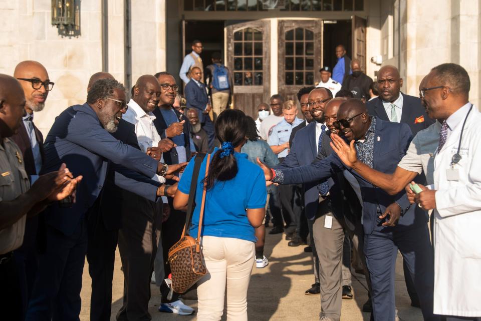 Members of the community welcome students at Lanier High School in Montgomery, Ala., on Wednesday, Sept. 14, 2022.