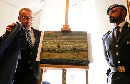 Director of Amsterdam's Van Gogh Museum Axel Ruger (L) unveils a painting by the Dutch artist Vincent Van Gogh, that was stolen in Amsterdam 14 years ago, during a news conference in Naples September 30, 2016. REUTERS/Ciro De Luca