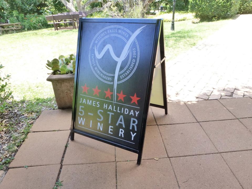 A winery featuring a black sign boasting their 5 Star James Halliday rating