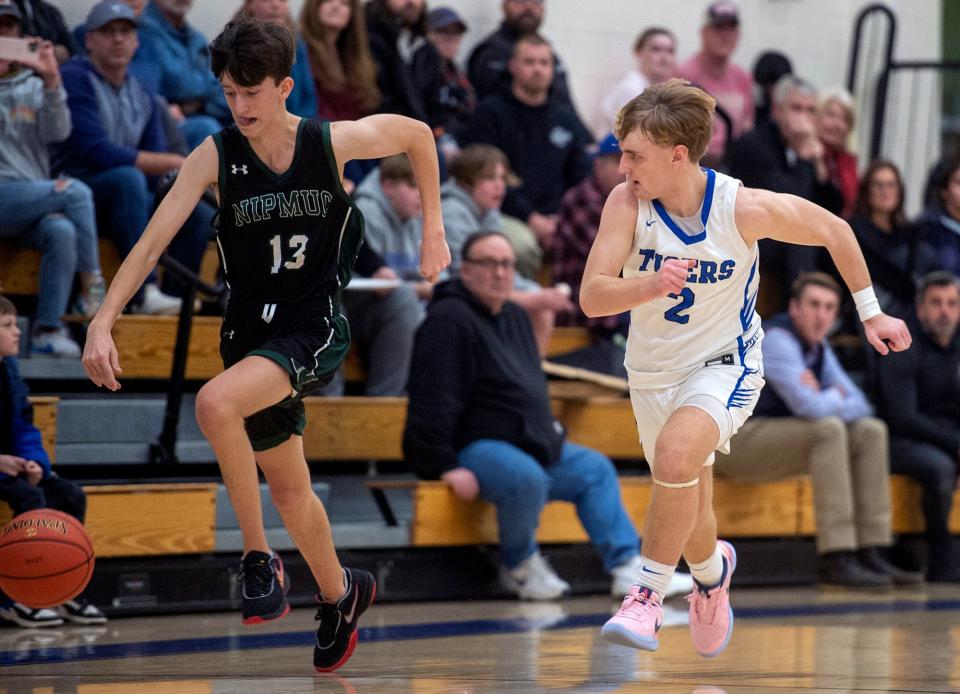 Nipmuc High School's Brayden Kelly pursued by Douglas High School's Isaac Gosselin, Jan. 3, 2024.