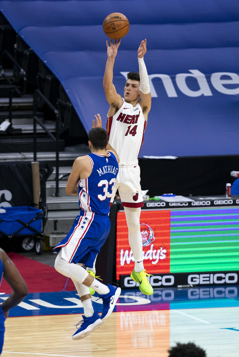 Miami Heat's Tyler Herro, right, releases a 3-point shot over Philadelphia 76ers' Dakota Mathias, left, during overtime of an NBA basketball game Tuesday, Jan. 12, 2021, in Philadelphia. (AP Photo/Chris Szagola)