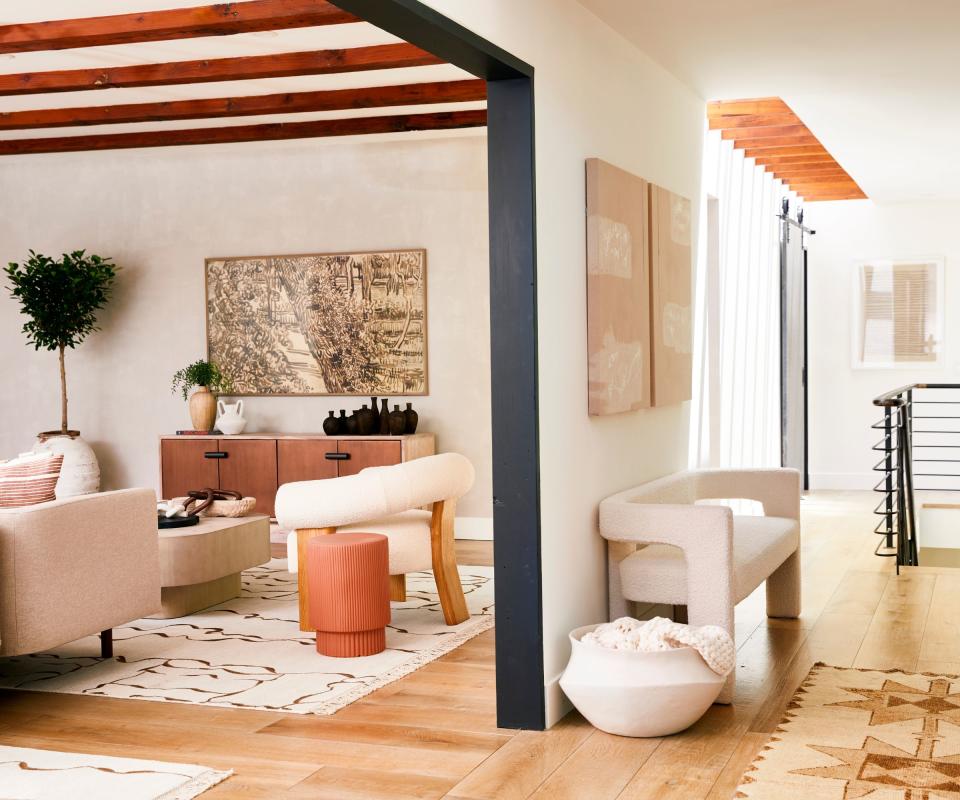 hallway with curved bench and view to living room and cream sofas