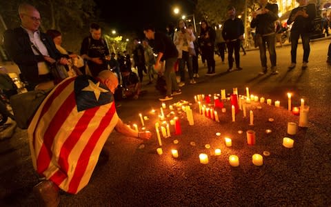 People light candles at a protest in downtown Barcelona  - Credit: ALEJANDRO GARCIA/EPA-EFE/REX