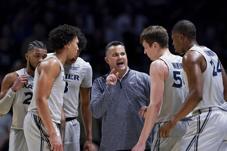 Xavier coach Sean Miller, center, speaks with players prior to an NCAA college basketball game against Houston, Friday, Dec. 1, 2023, in Cincinnati. (AP Photo/Jeff Dean)