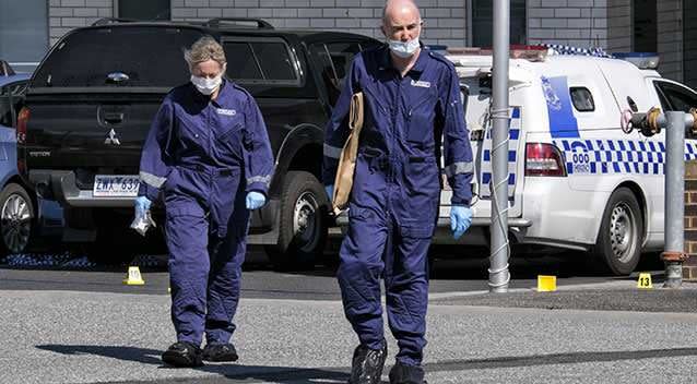 Forensic officers examine the scene where a teenage terror suspect was fatally shot after stabbing two police officers at Endeavour Hills. Photo: Getty