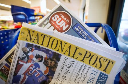 Toronto Sun and National Post newspapers are posed in front of a news stand in Toronto, October 6, 2014. REUTERS/Mark Blinch