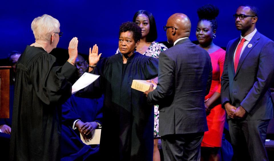 Lisa Holder White, center left, is sworn in as a justice of the Illinois Supreme Court by Justice Mary Jane Theis during a ceremony at the Abraham Lincoln Presidential Library and Museum on Thursday, July 7, 2022.