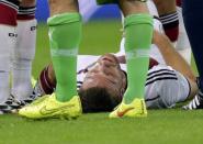 Germany's Shkodran Mustafi lies on the pitch injured during their 2014 World Cup round of 16 game against Algeria at the Beira Rio stadium in Porto Alegre June 30, 2014. REUTERS/Henry Romero