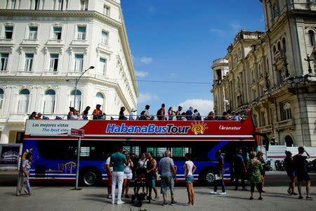 Tourists disembark from a Chinese-made double-decker Yutong bus in Havana, Cuba, February 10, 2017. Picture taken February 10, 2017. REUTERS/Alexandre Meneghini