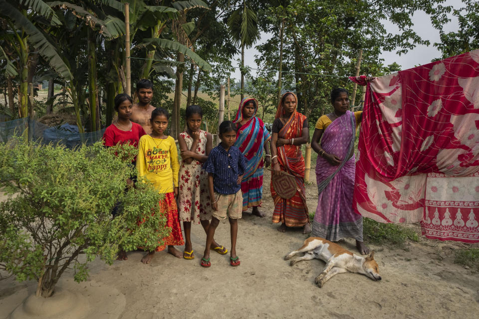 Members of the Biswas family, the majority of whom have not been able to prove their Indian citizenship, look on as their relatives talk to the Associated Press in Murkata village, north eastern Assam state, India, April 15, 2023. Nearly 2 million people, or over 5% of Assam's population, could be stripped of their citizenship unless they have documents dating back to 1971 that show their ancestors entered the country legally from neighboring Bangladesh. (AP Photo/Anupam Nath)