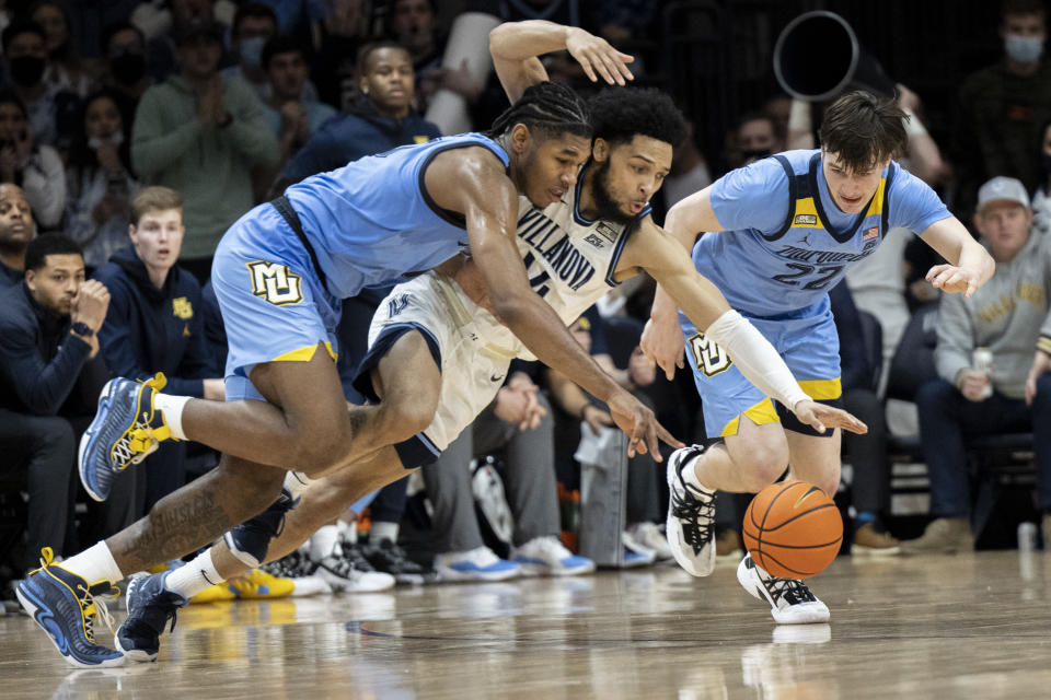 Villanova guard Caleb Daniels (14) and Marquette forward Justin Lewis (10) and guard Tyler Kolek (22) chase a loose ball during the second half of an NCAA college basketball game, Wednesday, Jan. 19, 2022, in Villanova, Pa. (AP Photo/Laurence Kesterson)