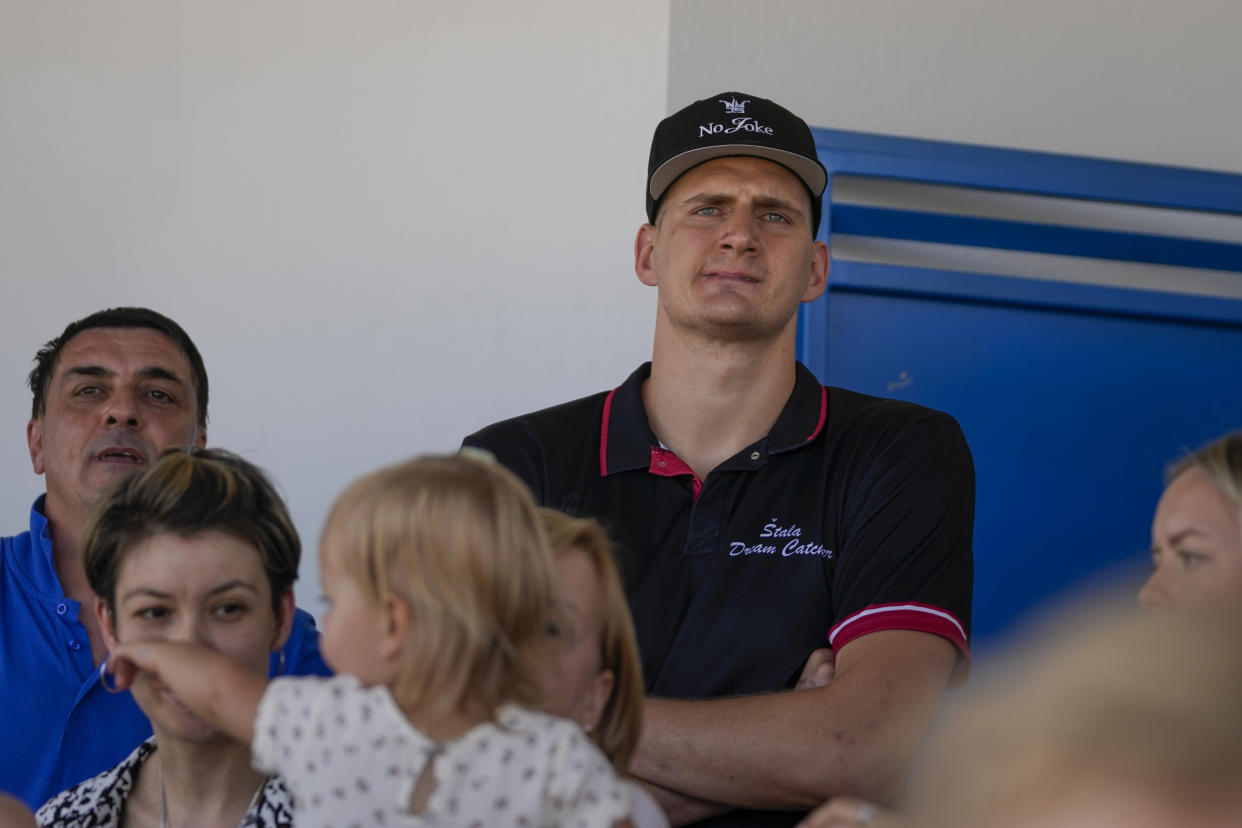 Denver Nuggets star Nikola Jokic watches a harness race at the hippodrome in the northern Serbian town of Sombor, Sunday, June 18, 2023. Jokic came to Serbia after the Denver Nuggets won the NBA Championship with a victory over the Miami Heat in Game 5 of basketball's NBA Finals. (AP Photo/Darko Vojinovic)