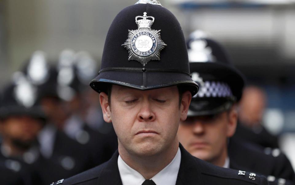 Police officers honour Pc Keith Palmer near Southwark Cathedral on Monday  - Credit: STEFAN WERMUTH/Reuters