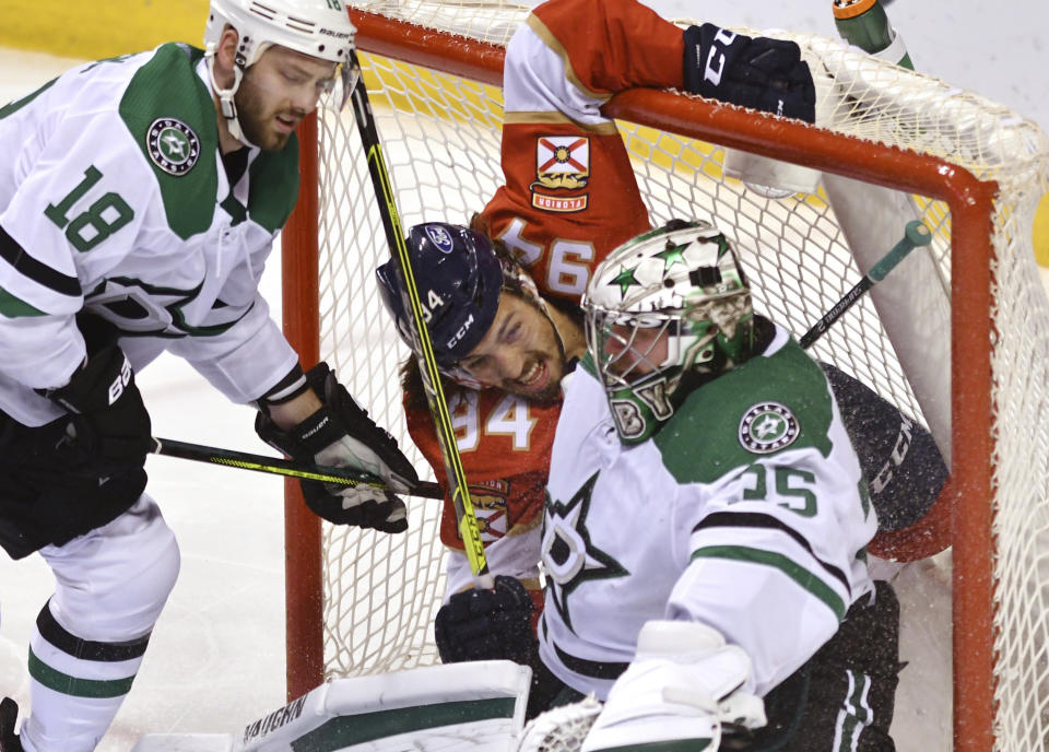 Florida Panthers left wing Ryan Lomberg (94) winds up in the net with Dallas Stars goaltender Anton Khudobin (35) as Dallas Stars center Jason Dickinson (18) looks on during the second period of an NHL hockey game Wednesday, Feb. 24, 2021, in Sunrise, Fla. (AP Photo/Jim Rassol)