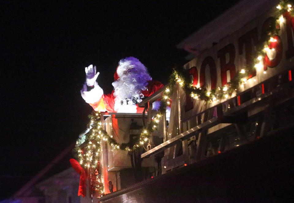 Santa Claus waves as Portsmouth celebrates its holiday parade and tree lighting Saturday, Dec. 2, 2023.