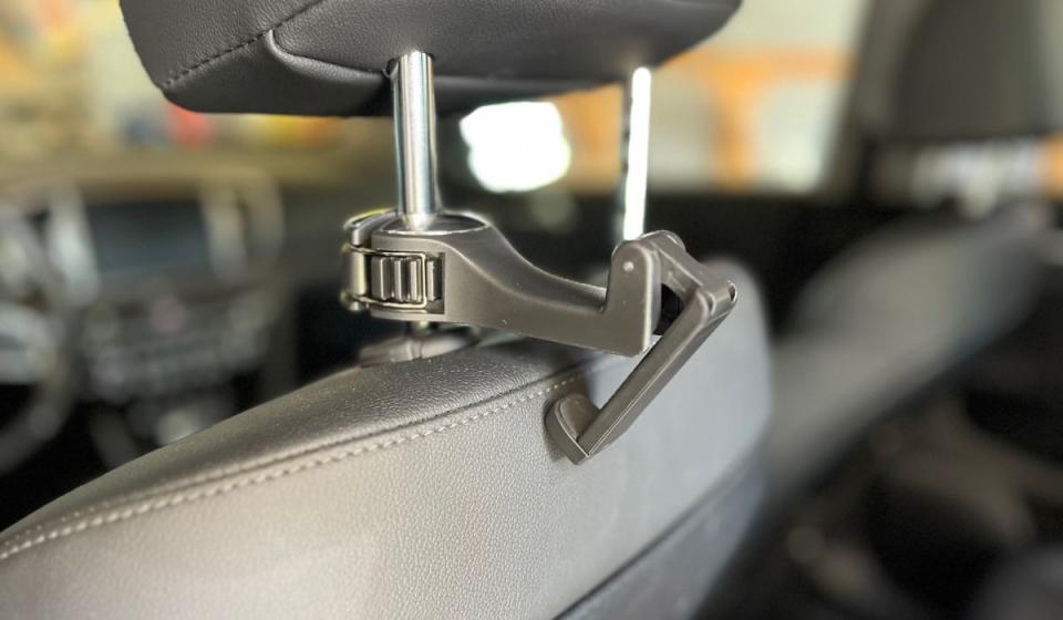 Here's what happens if the hook isn't mounted quite high enough on the headrest post; the fold-out phone mount can't quite clear the seat. (Photo: Rick Broida/Yahoo)
