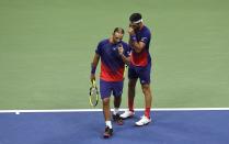 Robert Farah, right, and Juan Sebastian Cabal, both of Colombia, talk during the final doubles match against Marcel Granollers, of Spain, and Horacio Zeballos at the U.S. Open tennis championships Friday, Sept. 6, 2019, in New York. (AP Photo/Sarah Stier)