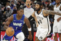 Minnesota Timberwolves forward Anthony Edwards (1) works past Brooklyn Nets forward DeAndre' Bembry (95) in the first quarter of an NBA basketball game Sunday, Jan. 23, 2022, in Minneapolis. (AP Photo/Bruce Kluckhohn)