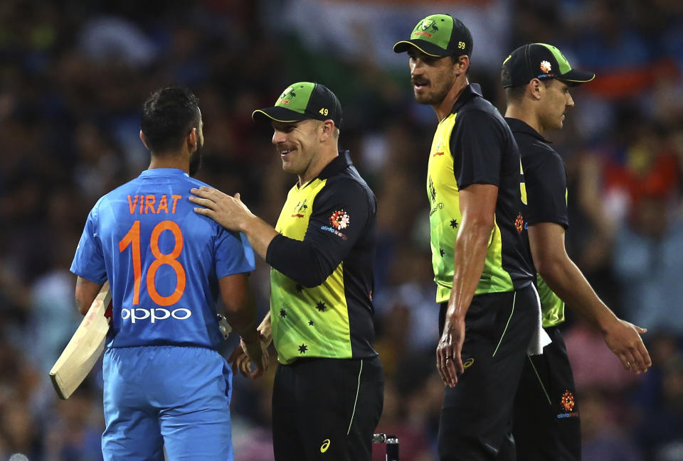 India's Virhat Kohli, left, is congratulated by Australia's captain Aaron Finch after winning their Twenty20 cricket match in Sydney, Sunday, Nov. 25, 2018. (AP Photo/Rick Rycroft)