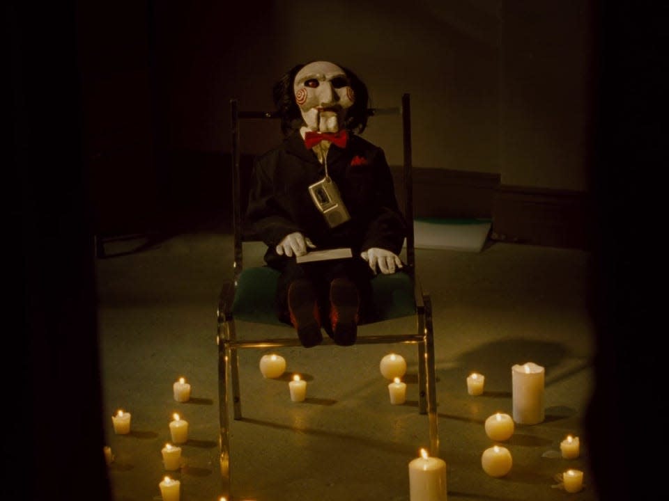 Billy the puppet on a chair in "Saw IV."