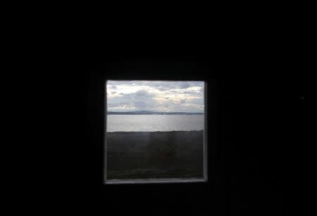 A view of Lake Iesjavri from the window of a small cabin, in the Finnmark Plateau, Norway, June 15, 2018. REUTERS/Stoyan Nenov/Files