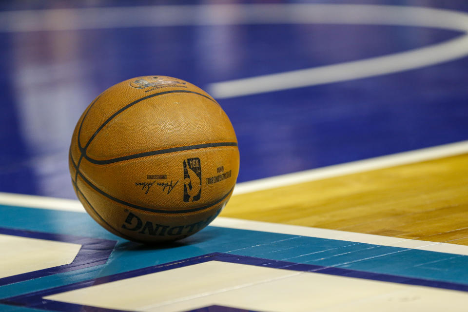 A basketball rests at the baseline during a timeout in an NBA basketball game between the Charlotte Hornets and the Milwaukee Bucks in Charlotte, N.C., Sunday, March 1, 2020. Milwaukee won 93-85. (AP Photo/Nell Redmond)