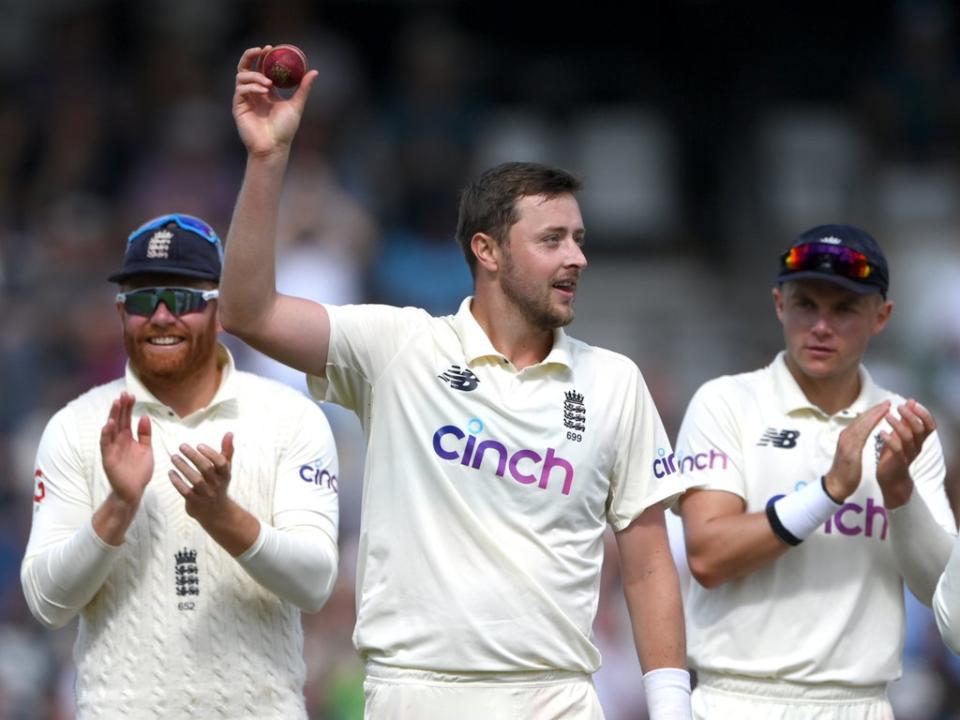 England bowler Ollie Robinson holds aloft the ball after taking his five wickets in the second innings  (Getty)