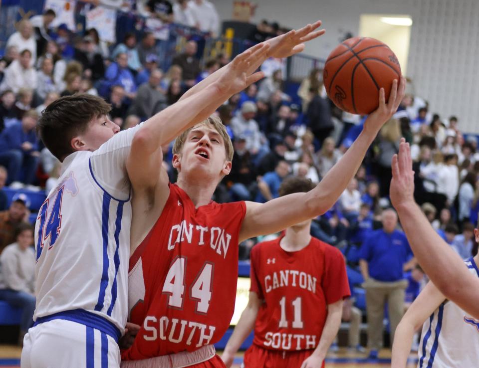 Canton South’s Brady Noll attempts to shoot over Tuslaw’s Max McMerrell on Friday, Feb. 18, 2022.