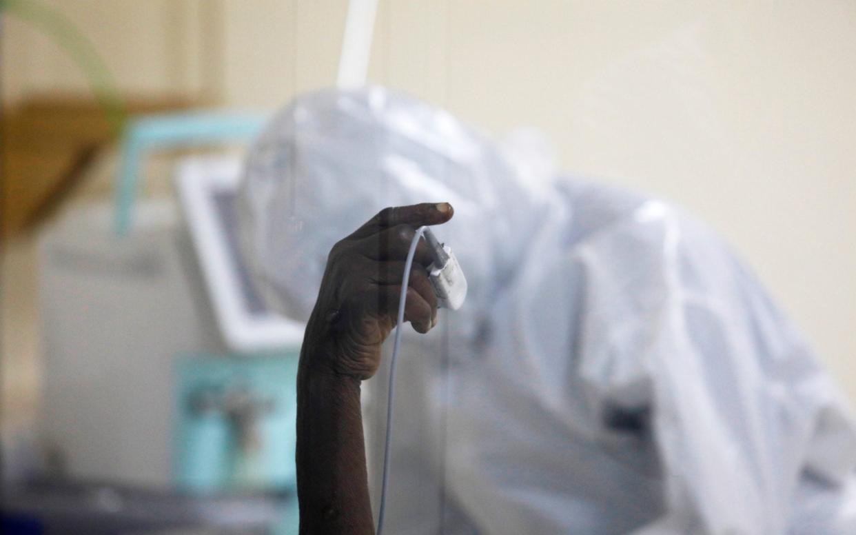 A coronavirus disease patient holds up his hand inside the COVID-19 ICU of Machakos Level 5 Hospital, in Machakos, Kenya October 28, 2020 - Reuters